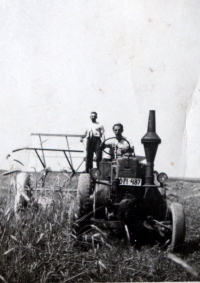 The witness's father on the first tractor in the village 
