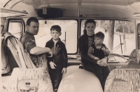 With father, mother and younger brother in the bus his fatehr was driving / about 1962