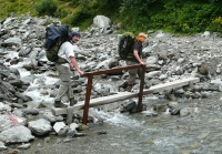 Petr and Věra Náhlíkovi in the Alps, crossing a stream (2010)