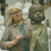 Marie Uchytilová while modelling a sculpture of a Lidice girl (1970s)