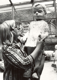 Marie Uchytilová holding a plaster sculpture of a small girl (1970s)