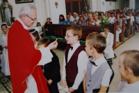 Radomil Kaláb services the First Holy Communion to a child