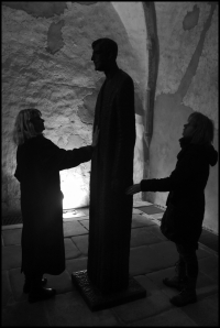 Eva Vorlíček touching the statue for Pastor Josef Toufar by Olbram Zoubek / Zahrádka 2017