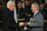 Receiving the Medal of Merit from the hands of the President of the Republic