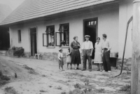 His parents and his cousin in front of the original house in Bernartice