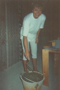 Magda prepares mortar for plastering, a house near Milano 1991

