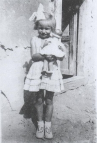 Magda, as a five years old child in a backyard in Stropkov, 1950