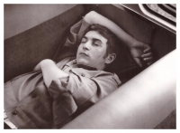 The singer Pavel Sedláček lying down and sleeping after a successful performance on the way back to Prague

