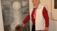 Dana Puchnarová is posing with her painting in the Olomouc Museum of Art during an exhibition in 2007.