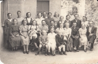 Anastázie Lorencová in the polka dot dress (top row, on the edge of the building), circa 1941