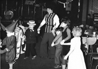 Anna Musilová, head of the Company Club of Vlněna Brno with children during a party, 1984