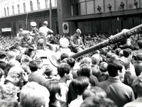 Soviet tank under siege by the crowds in front of the post office at the main railway station in Brno 
