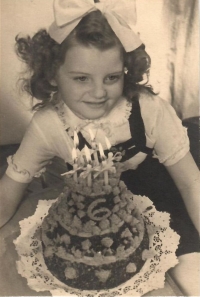 With a cake on her sixth birthday, Jungmannovo náměstí photographic studio, Prague, 1950