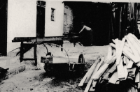 Jan Odstrčil is sawing off beams after a fire of house in 1961