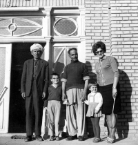 Květa Dostálová with her children, a cook and a water bearer in front of their house in Kabul / around 1967 

