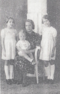 With his mother and sister as a child