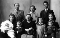 Adolf Ruš (on the right, second row) with his mother (in front of him, holding his brother), his grandmother (in the middle) and other relatives / Třinec / the 1950s 