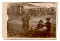 Lavrentiya Talanchuk (far left) takes care of the neighbors' children at the special settlement, 1950s