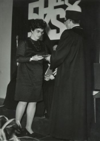 Graduation, Iva Ondráčková receives her red diploma - (on the curtain behind her is a large inscription "50 years of the Communist Party"), Brno, summer 1971 
