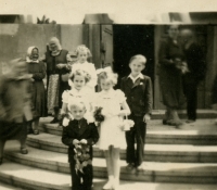 Alexander Bory with his sisters in front of a church