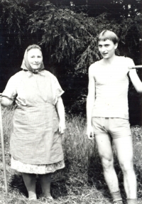 Pavel Štrobl with his grandmother Viktorie during hay making (beginning of the 1980s) 
