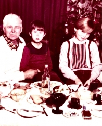 A photograph of Ewa's grandfather, herself and her brother, from Christmas time 1986.

