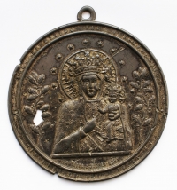 Medallion of Black Madonna of Czenstochowa with a hole punched by a piece of shrapnel