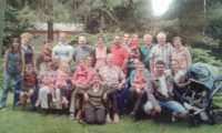 Petr (top row, fifth from left) with his wife Maruja (sitting on the lawn) at a family reunion in Ždáň. Slapy, 2016