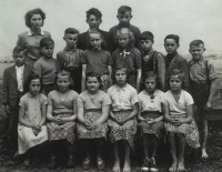 Marie in the fifth grade, barefoot at the bottom in the middle, 1958
