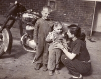 The contemporary witness with his father's motorbike in front of their house in Letná, 1959