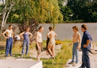 In the garden of a novitiate in Kolín (former monastery and a Capuchin garden), 1993. During socialism there was an open-air cinema. After being returned to the Church, the garden was being renewed in a park landscaping style. (from the left: Cyril John, first year novice, next to him, in a blue t-shirt Josef Horehleď, second year novice, Jan Čunek, at that time novice mister’s assistant, from the back Peter Jelen, second year novice, Pavel Hruda, second year novice, and on the right, Petr Sýkora, first year novice) 