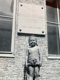 Young Eva in front of her grandfather's memorial plaque