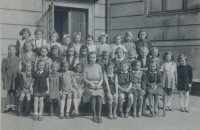 Anna Vyoralová with her sister Jana (bottom row, left) in school photo