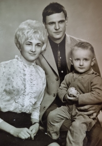 With his parents at the age of three