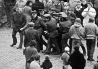 Pavel Záleský dragged by SNB officers / Gathering for the release of Augustin Navrátil from a psychiatric hospital / Olomouc / 1988 / Commentary by the witness: "The gentleman with the bag in front of me is my father. He shouted at me not to do anything to them. I replied that I wasn't doing anything to them, they were doing it to me!" / photo by Oldřich Kučera