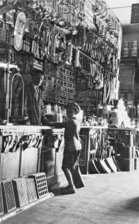 Interior of the Janeček's, store, Pavel Janeček Sr. behind the counter (1932)
