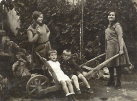 Four siblings. Hedvika, on the wheelbarrow, left. Around 1930