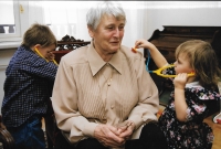 Granddaughter and grandson are "examining" their grandma. 1999
