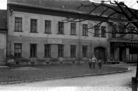 In front of the printing house, already occupied by the Styl clothing factory at the time, Anna Krčmařová with her grandchildren Dagmar and Eduard, 1957 
