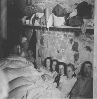 A cellar in which they spent the last days of the war. Luděk Půlpitel is hiding under a blanket 

