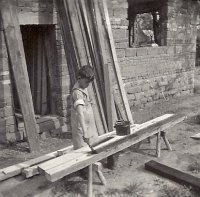 Ten-year-old Lubomír is helping with the construction of the house in Městská Habrová, May 1960.
