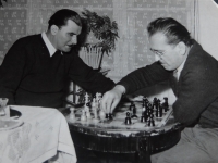 Father Tibor (left) plays chess with Ľudovít Pech