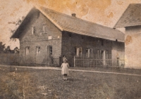 Růžena in front of the family farm buildings. Around 1947