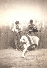 Making music with his peers from Hrubá Vrbka. From the left: Jiří Tomešek - violin, Jiří Hudeček - accordion, Martin Hrbáč wearing a cap - violin. Around 1950
