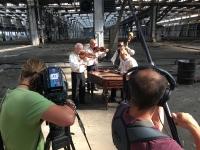Martin Hrbáč with former members of his ensemble posing for the Czech Television crew making a documentary about J. Smutný in the former Ironworks /South Moravian Pipe Manufacturing Plant in Veselí nad Moravou, 2020 


