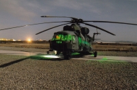 A helicopter lit up at a base in Afghanistan