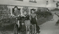 On a bicycle in front of the house, around 1954