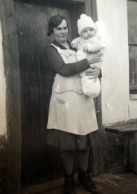Mother holding Věra's brother in her arms