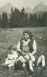 Photo of mom and siblings in nature.

