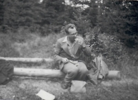 Jan Kadlec having a snack on a log in the forest, circa 1959